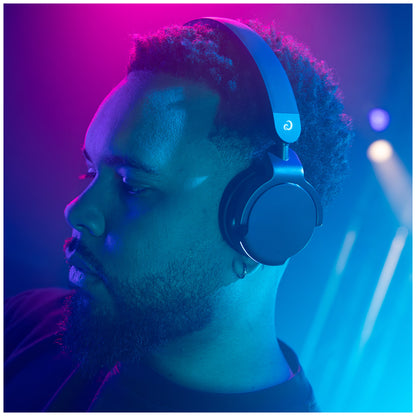 AlphaTheta HDJ-F9 Professional Wireless DJ Headphones - lifestyle image of a DJ wearing the HDJ-F9's.