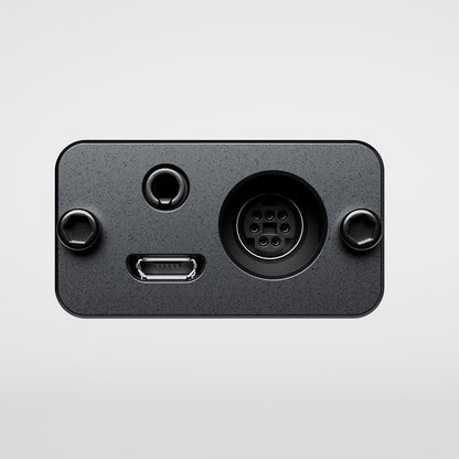 Black electronic component with various ports on a light gray background